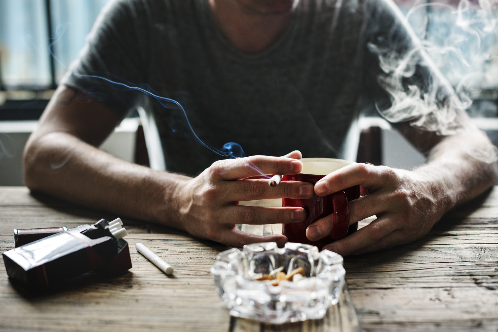 Одинокий мужчина не курит не пьет. Мужчина с сигаретой за столом. Кофе и сигареты. Мужская рука с кофе. Парень курит за столом.