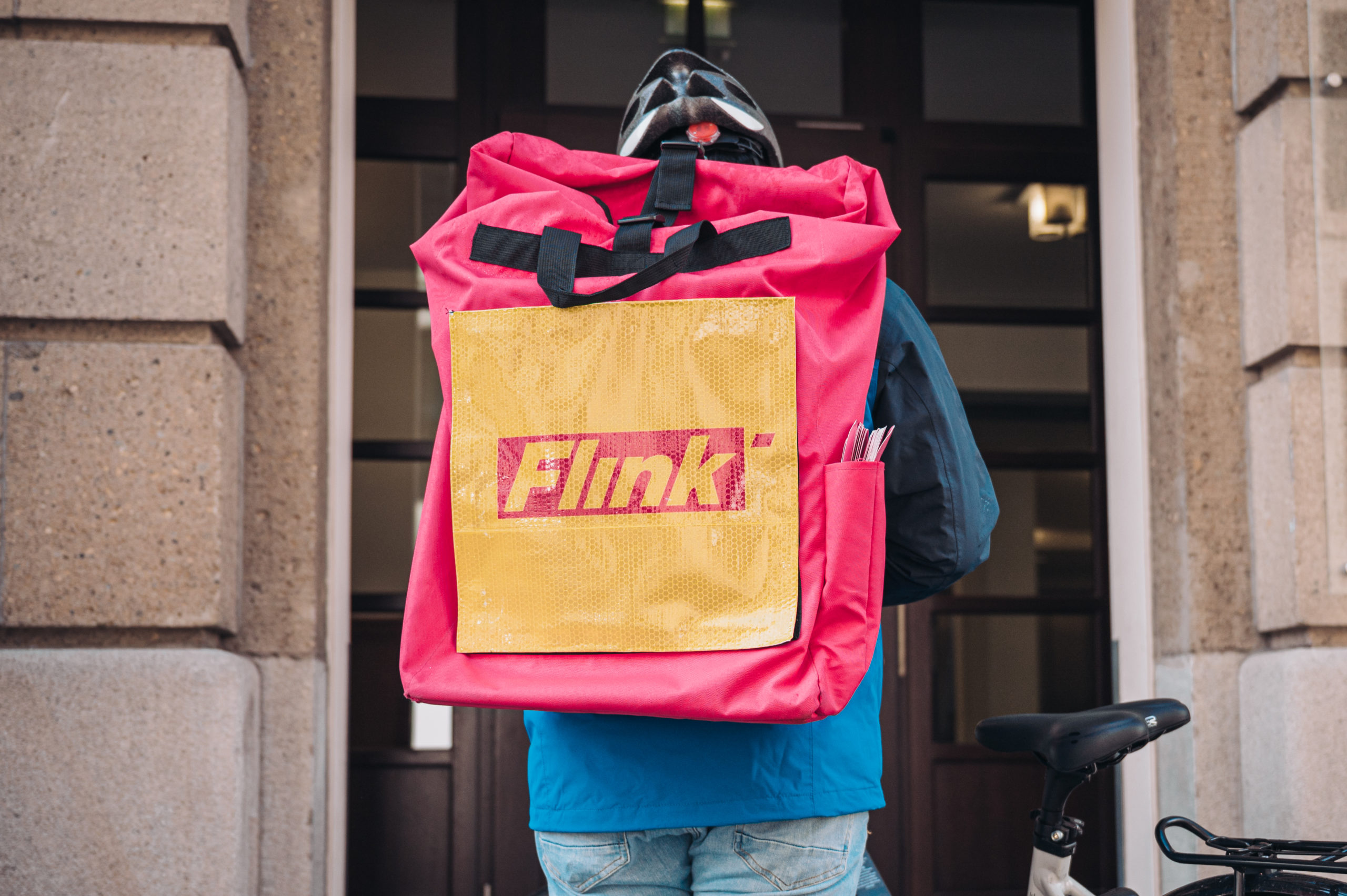 Ein Flink-Rider vor einer Haustür. Foto: Flink
